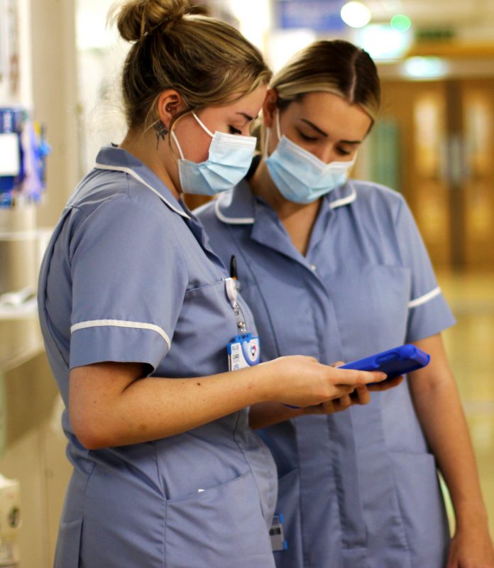 Nurses looking at a tablet screen